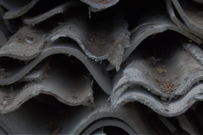 Asbestos roofing piled on top of one another.